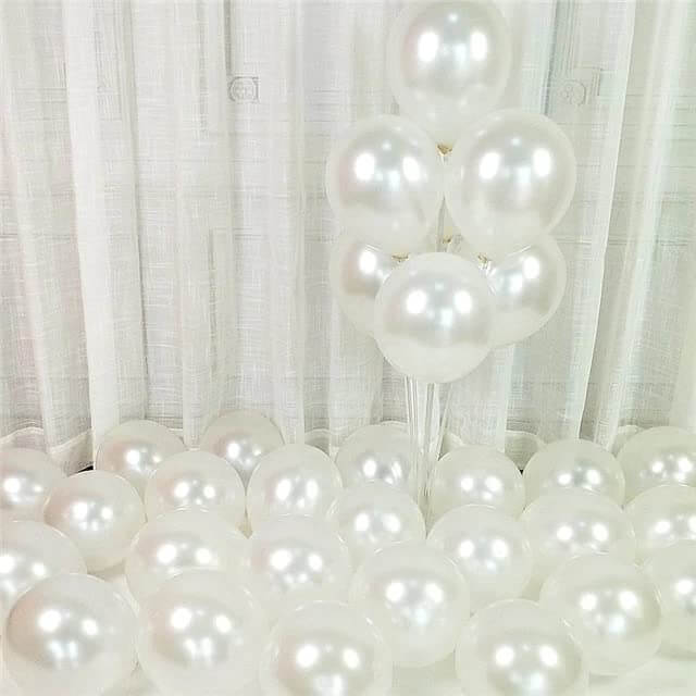 White metallic balloons arranged decoratively for party and celebration occasions.