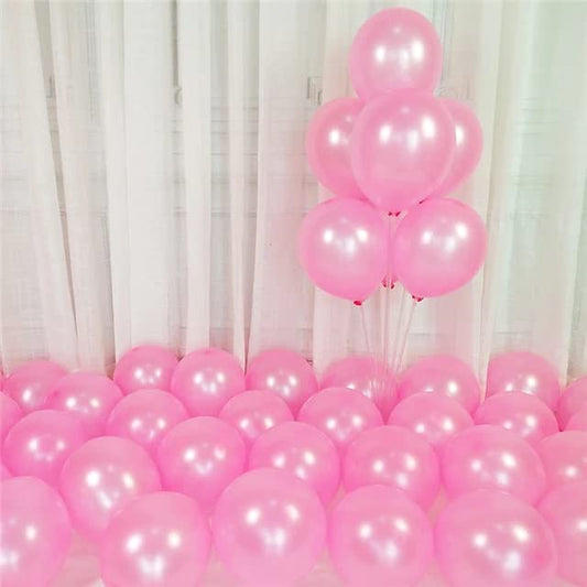 Pink balloons arranged artistically on the floor, perfect for parties and celebrations.