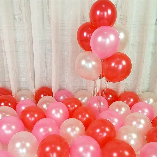 Vibrant assortment of red and pink balloons, perfect for birthday parties, anniversaries, and celebrations.
