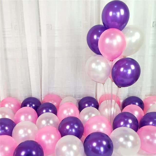 Colorful purple, pink, and white balloons arranged for festive decorations, perfect for parties and celebrations.
