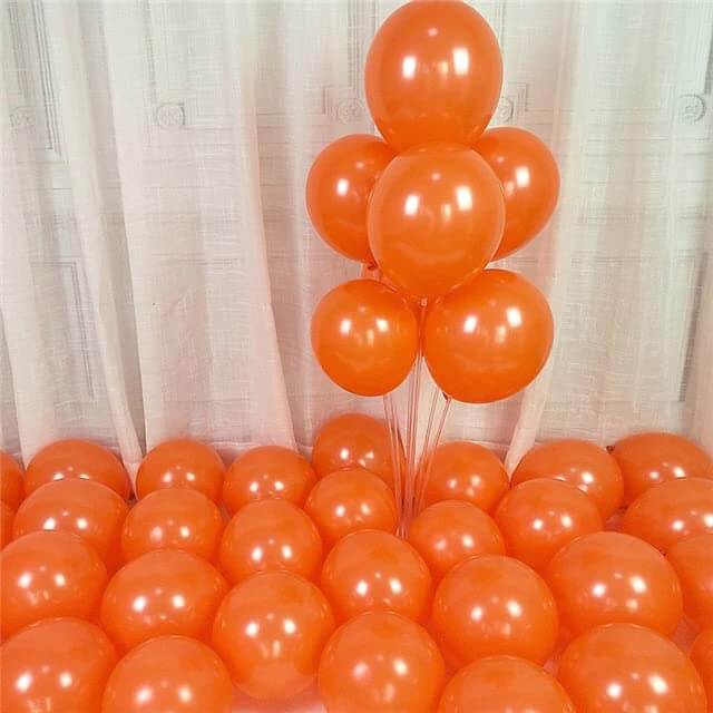 Vibrant orange balloons arranged for celebrations, creating a festive atmosphere ideal for parties and events.