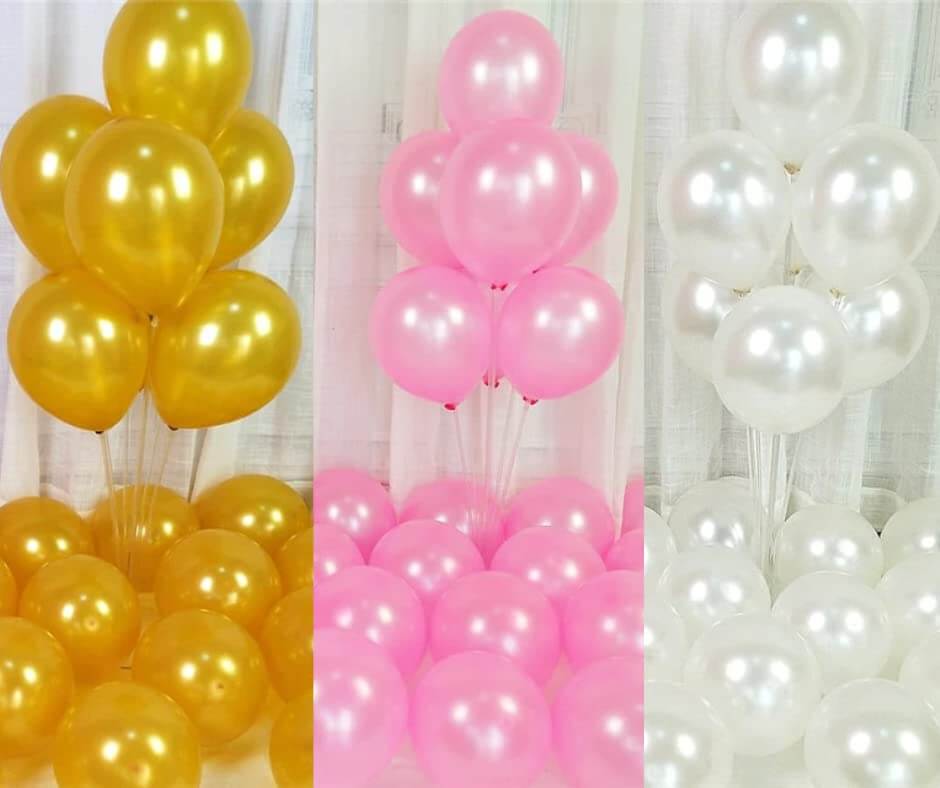 Colorful gold, pink, and white balloons arranged for festive decorations, perfect for parties and celebrations.