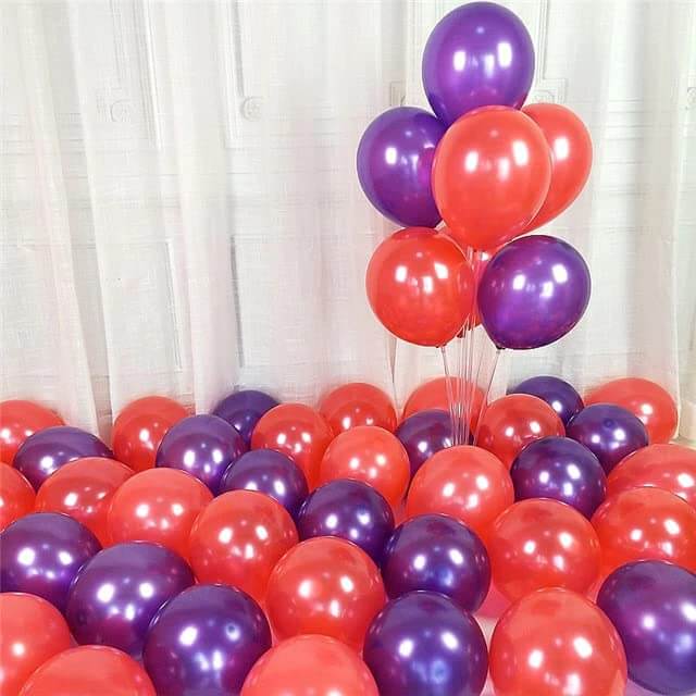 Colorful display of red and purple balloons perfect for festive celebrations and party decorations.