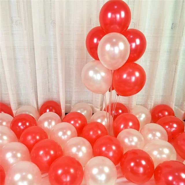 Pack of red and white balloons on the floor for celebration, birthday, or wedding decoration.